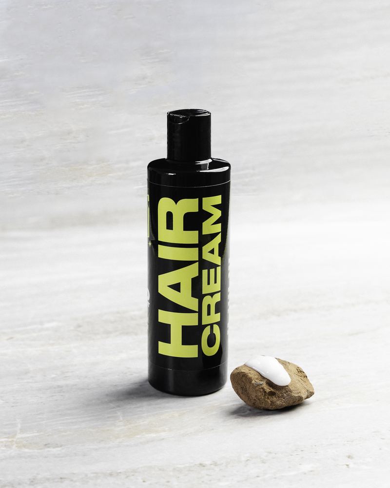 Jefes Hair Cream bottle on a stone surface