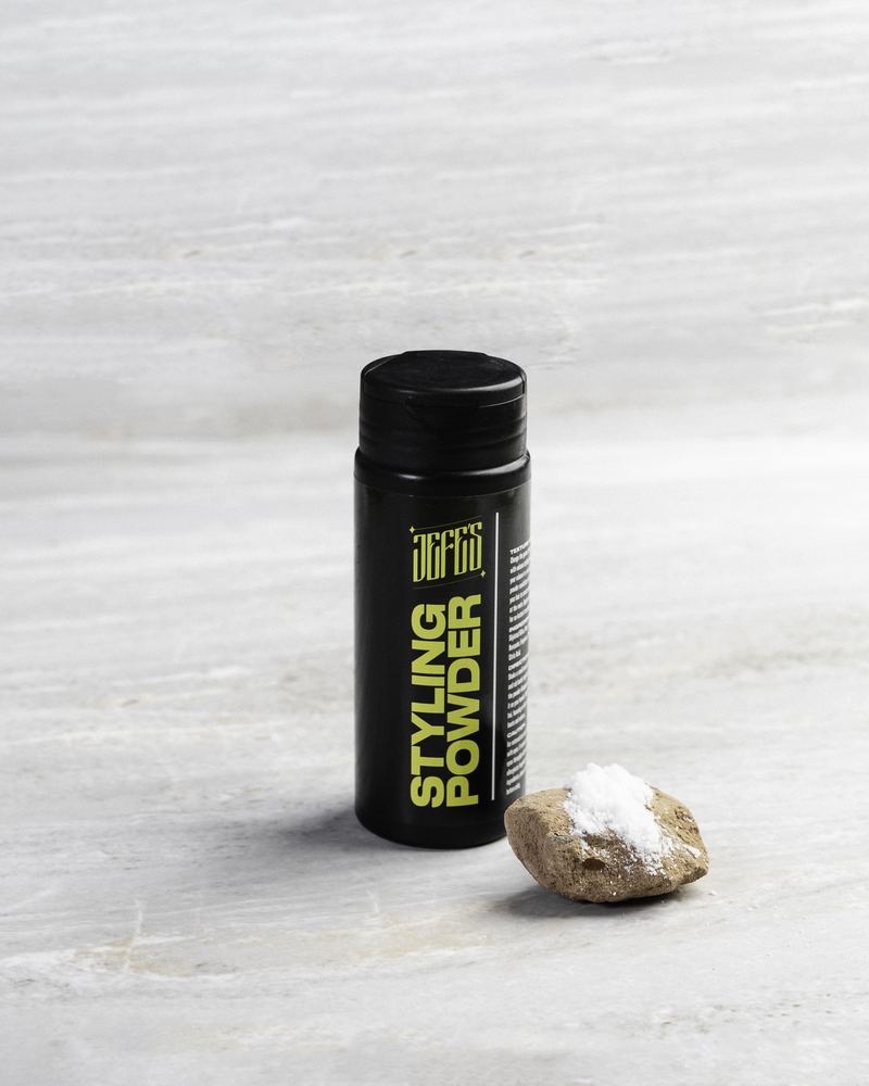 Jefes Styling Powder bottle on a stone surface